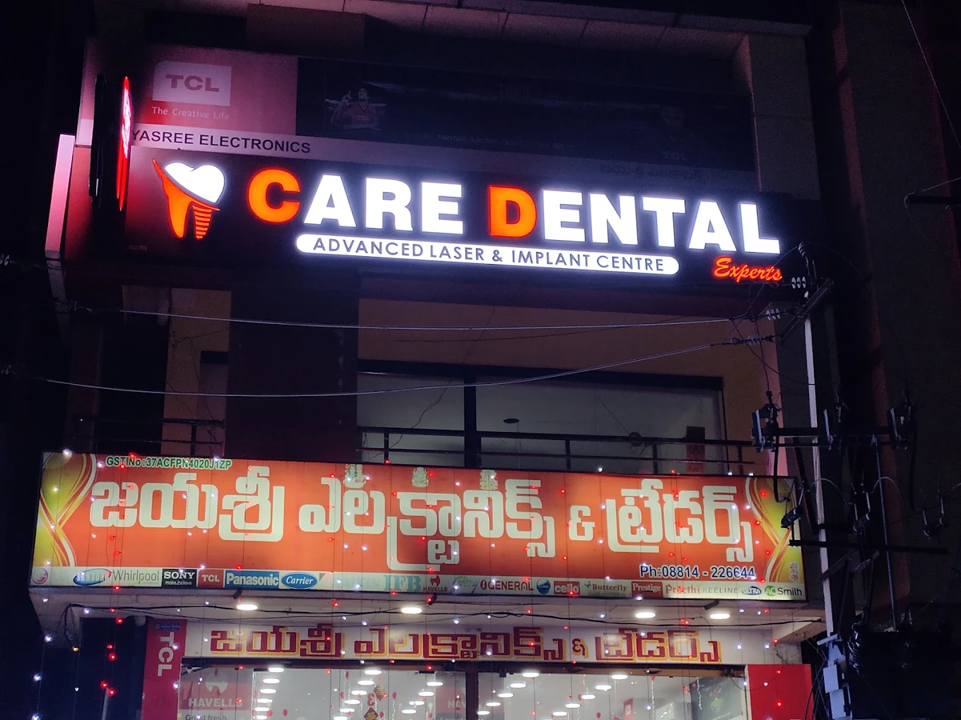 The Main Road signboard, lit at night, Care Dental Experts, Palakollu